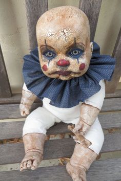 a creepy doll sitting on top of a wooden bench