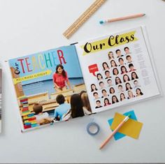 an open book with pictures and pencils next to it on a white table top