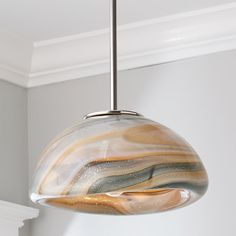 a glass light hanging from a ceiling in a room