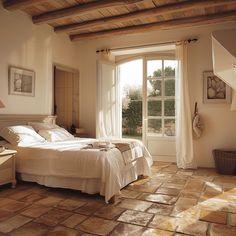 a bed room with a neatly made bed next to a window and a stair case