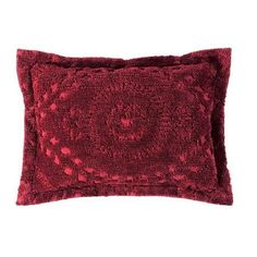 a red decorative pillow on a white background