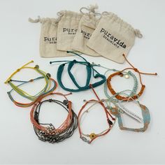 Lot Of 12 Pura Vida Pull Tie Adjustable Bracelets You Get All 12 2 Have Tags, Others Are Nwot Or Like New. 4 Drawstring Bags Are Included One Has An Anchor Charm, One Has A Pineapple & One Has A Sunflower Surfer Beachy Summery Casual Artisan Handmade Festival Friendship Good Cause Eco Earth Friendly Stacking Layered California Skater Wide Flat Braided Set Lot Pack Bundle Beaded Seed Bead Original Club Braided Charm String Woven Stack Charity Pack Of Multicolor Boho Ombr Colorful Tie Knot Knotted Vida Blue, Festival Bracelets, Eco Earth, Double Chain Bracelet, Anchor Charm, Rose Gold Charms, Soft Heart, Braids With Beads, Puka Shell