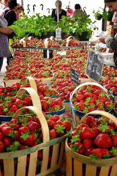 baskets filled with strawberries on display at an outdoor market