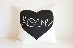 a black and white pillow with the word love on it