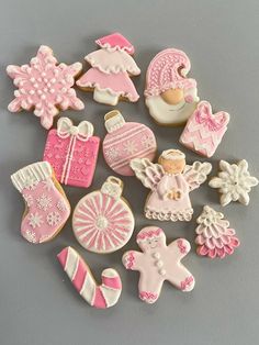 a pile of decorated cookies sitting on top of a gray table next to each other