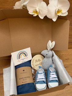 a box filled with blue and white shoes, a stuffed animal, and other items