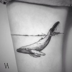 a black and white photo of a whale's tail on the side of a woman's thigh