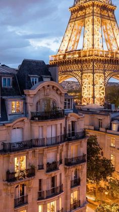 the eiffel tower lit up at night in paris, france with its lights on