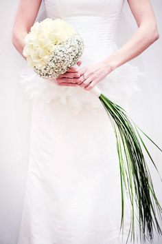 a woman in a wedding dress holding a bouquet