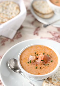 a bowl of soup and crackers on a table