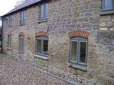 an old brick building with three windows on the side