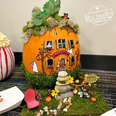 a fake pumpkin house is sitting on the ground