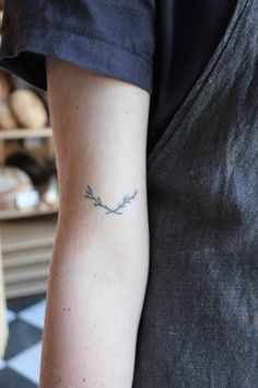 a person with a small tattoo on their arm