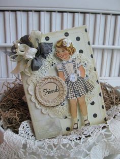 a close up of a greeting card with a doll on the front and an embellishment in the back