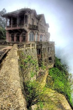 an old house on top of a cliff