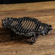 a small black comb sitting on top of a wooden table