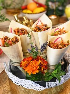 there are many different types of food in the vases on this tableclothed tray