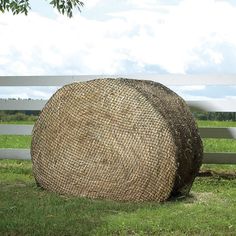 a large round hay bale sitting in the grass