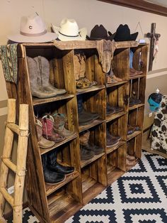 a wooden shelf filled with lots of boots and hats on top of it's shelves