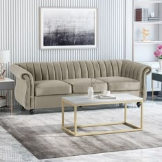 a living room filled with furniture and a coffee table in front of a blue wall