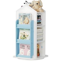 a white and blue book shelf with books on it's sides, next to a stuffed animal