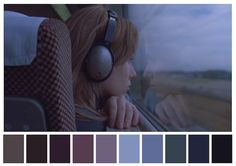 a woman wearing headphones looking out the window with color swatches in front of her