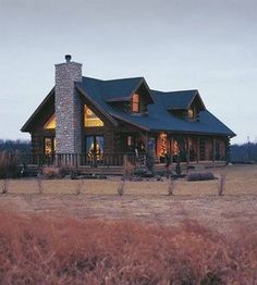 a large log house with a tall chimney in the middle of it's yard