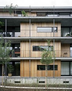 an apartment building with wooden balconies and balconies on the side of it