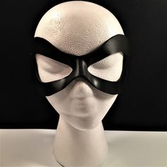 DESCRIPTIONAdd spice to your love life! This small, very lightweight, black leather mask is perfect for the beginner dominatrix or Lord of the Bedroom. Any color. Silver studs available. Waterproofed leather, glossy or matte finish, & several choices to affix the mask (cord, elastic, ribbon, waterproof cord, stick, or no holes for adhesive). Measurements: 3" high x 7" wide (tallest & widest points); 1" high between the eyes; 2.75" wide x 2.75" tall eye openings ---------------------------------- Lone Ranger Costume, Splatoon Costume, Robin Superhero, Comicon Costume, Ranger Costume, Masquerade Prom, Robin Cosplay, Superhero Masks, Superhero Cosplay