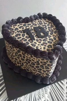 a leopard print cake with black icing and the number 9 on it's side