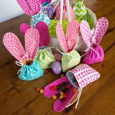 several bags filled with candy sitting on top of a wooden table next to an easter basket