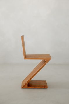 a wooden chair sitting on top of a white floor