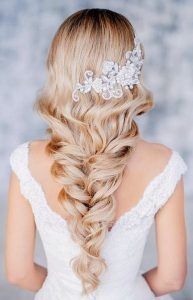 the back of a woman's head with long hair and a braid in it