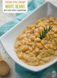 a white bowl filled with beans on top of a table