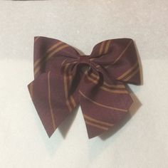 a close up of a bow tie on a white surface