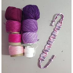 several skeins of yarn next to a crochet hook