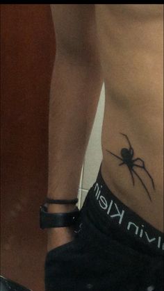 a person with a spider tattoo on their stomach