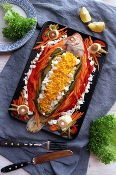 a platter with fish and vegetables on it