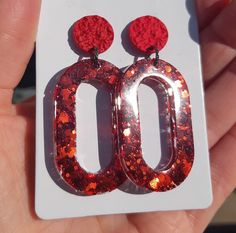 Light, shiny curls of geometric shape. Glitter Jewelry For Gifts, Glitter Jewelry Gift, Trendy Red Jewelry For Festive Occasions, Trendy Red Festive Jewelry, Glitter Drop Earrings As A Gift, Glitter Red Earrings For Gifts, Red Glitter Earrings For Gift, Red Glitter Earrings For Party, Red Glitter Jewelry For Party