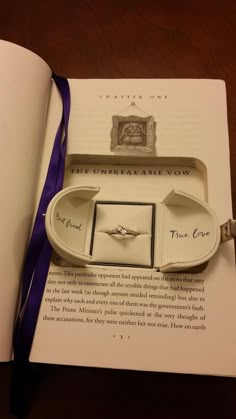 an open harry potter propposal book with ring boxes