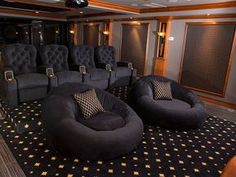 an empty theater room with black chairs