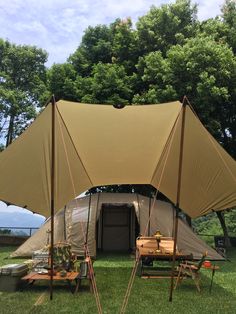 an outdoor tent set up in the grass