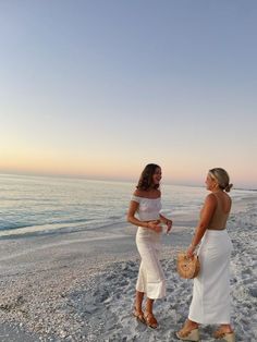 two women on the beach talking to each other