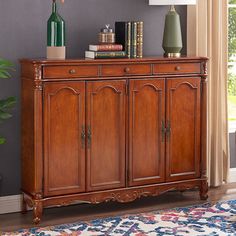 a wooden cabinet sitting on top of a rug