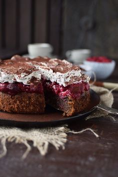 there is a cake that has been cut in half on a plate with a fork