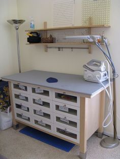 an ironing board sitting on top of a wooden cabinet