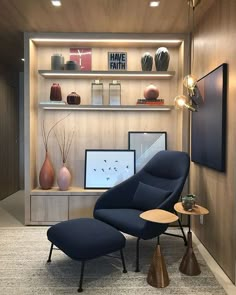 a chair and ottoman in a room with wood paneling on the wall behind it