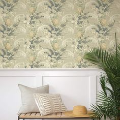 pineapple wallpaper in an entryway with a bench and potted plant