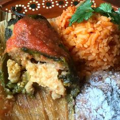 a plate with rice, meat and vegetables on it