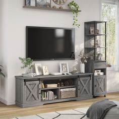 a living room with a large flat screen tv mounted on the wall and wooden shelves